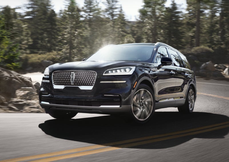 A Lincoln Aviator® SUV is being driven on a winding mountain road | Hooks Lincoln in Fort Worth TX