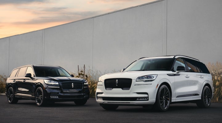 Two Lincoln Aviator® SUVs are shown with the available Jet Appearance Package | Hooks Lincoln in Fort Worth TX