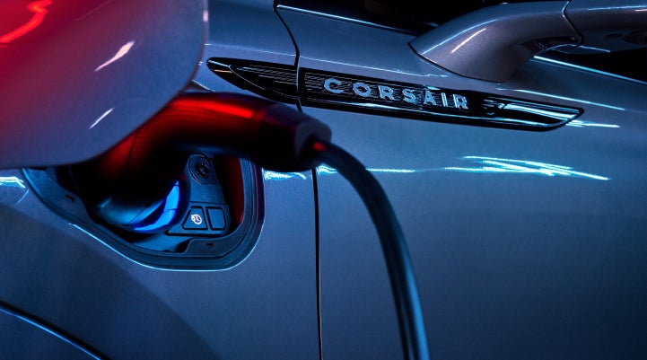 A charger plugged into the charging port of a 2024 Lincoln Corsair® Plug-in Hybrid model. | Hooks Lincoln in Fort Worth TX